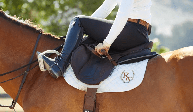 How do you properly adjust stirrups and reins for comfortable riding?