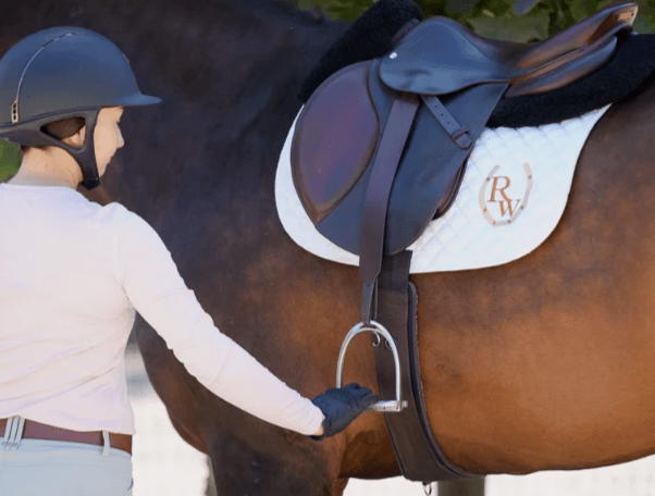 How do you properly adjust stirrups and reins for comfortable riding?